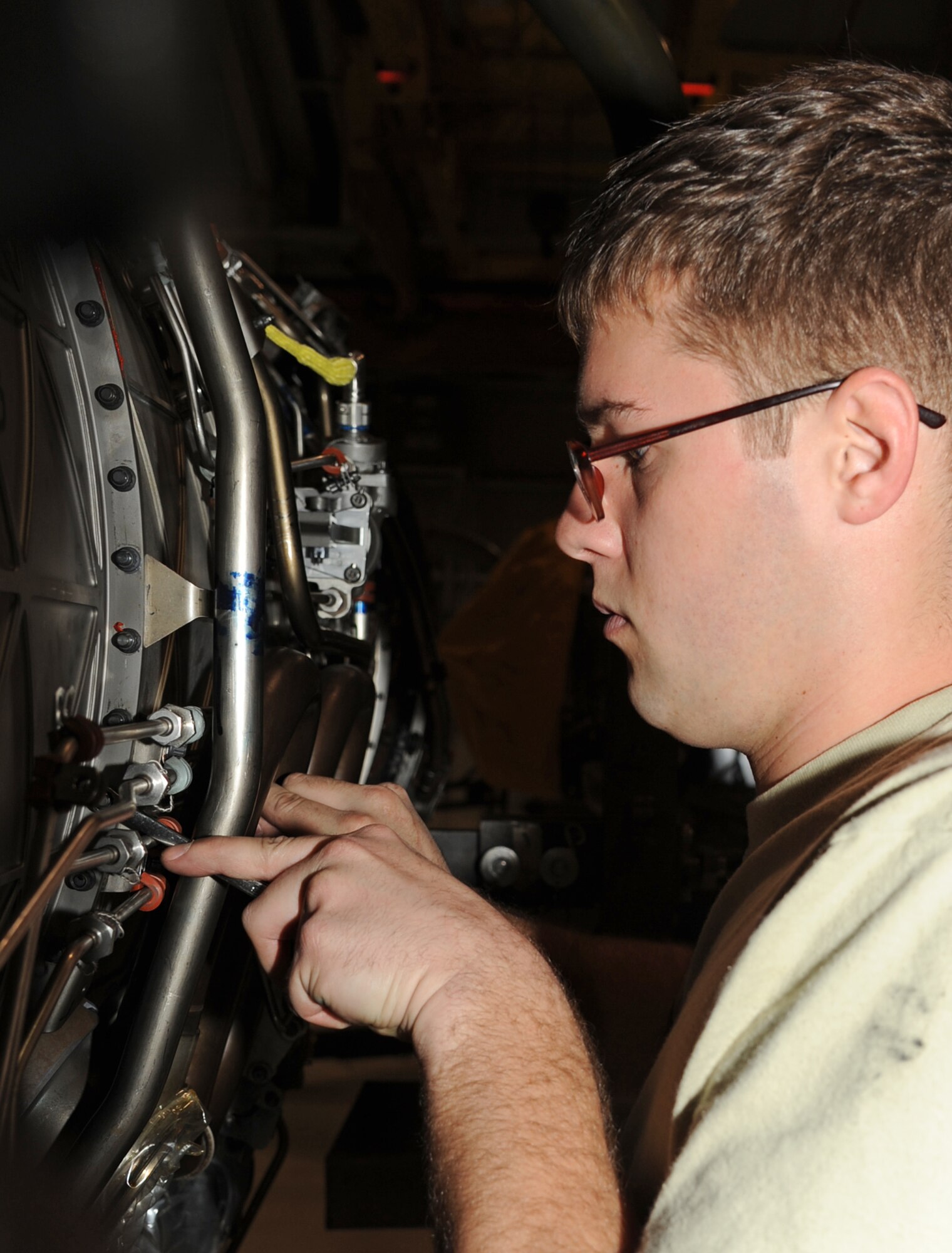 U.S. Air Force Airman 1st Class Joshua Tutolo installs fan duct mount bolts while performing F-15E Strike Eagle maintenance repairs at Seymour Johnson Air Force Base, N.C., Jan. 30, 2012. The bolts hold the engine’s outer cast together providing matting points for all outer components. Tutolo is a 4th Component Maintenance Squadron jet engine intermediate mechanic from Chardon, Ohio. (U.S. Air Force photo/Senior Airman Whitney Stanfield/Released)