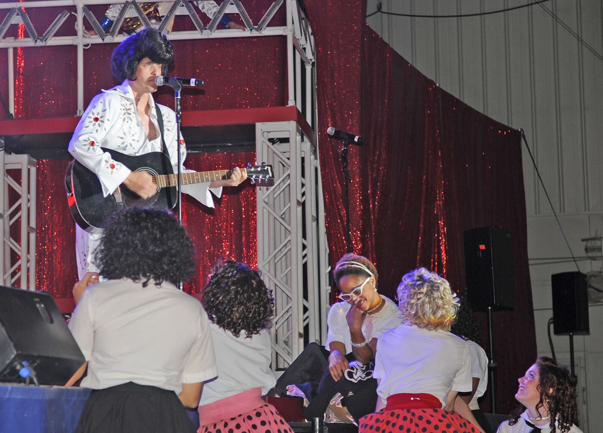 U.S. Air Force Senior Airman Cordero Nichols impersonates Elvis Presley during a Tops in Blue performance at Seymour Johnson Air Force Base, N.C., Jan. 27, 2012. The Tops in Blue group history spans 58 years. Since its first world tour in 1953, these Airmen have been featured in films, produced albums and appeared on national TV. (U.S. Air Force photo/Senior Airman Gino Reyes/Released)
