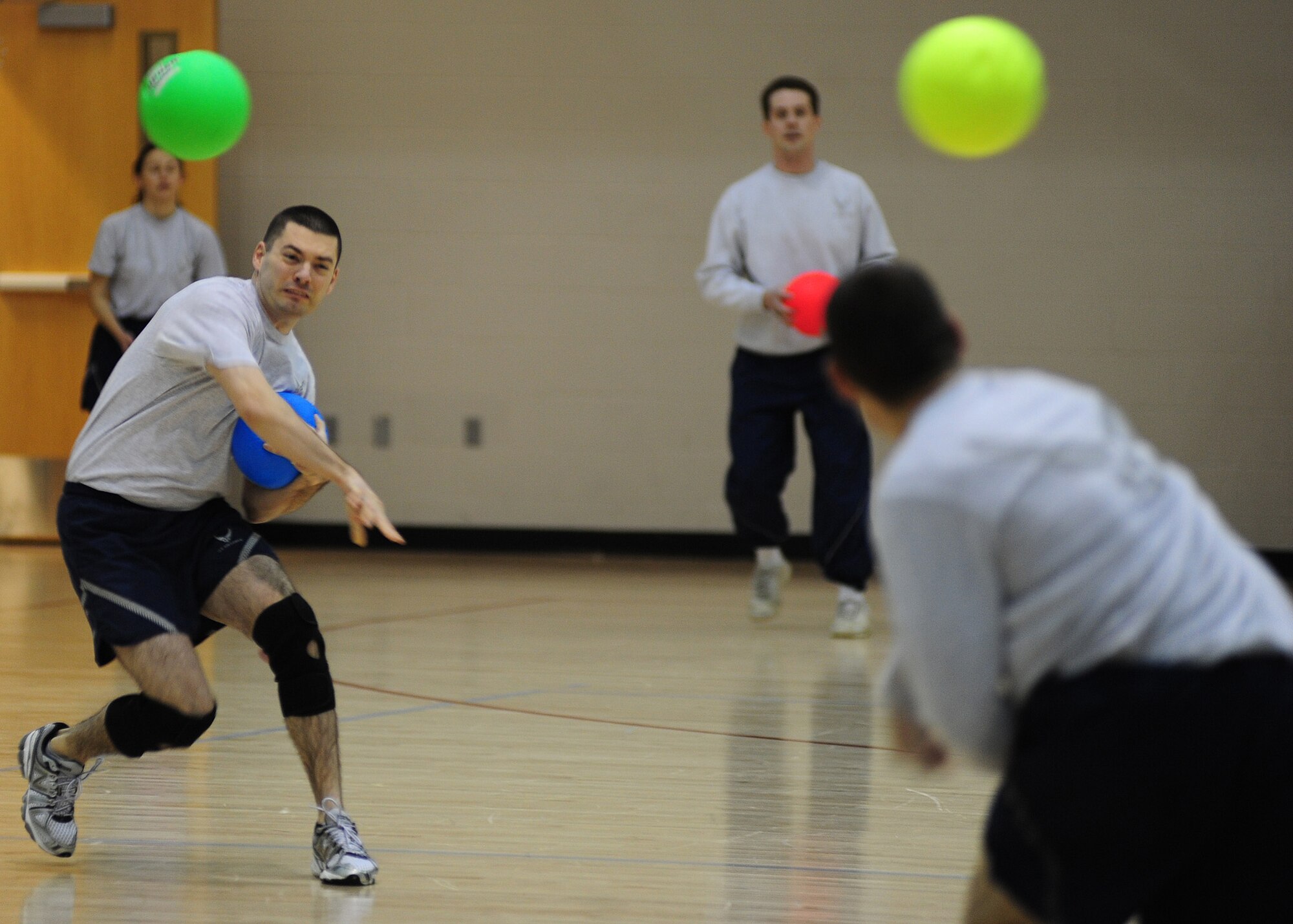 MINOT AIR FORCE BASE, N.D. -- Maj. Michael Rakowski, 5th Bomb Wing judge advocate, aims to strike out one of his opponents during a dodgeball tournament held at the McAdoo Sports and Fitness Center Jan. 27. Sports tournaments are held by the fitness center to provide Airmen an opportunity to engage in unit camaraderie and promote exercise. (U.S. Air Force photo/Master Sgt. David Miller)
