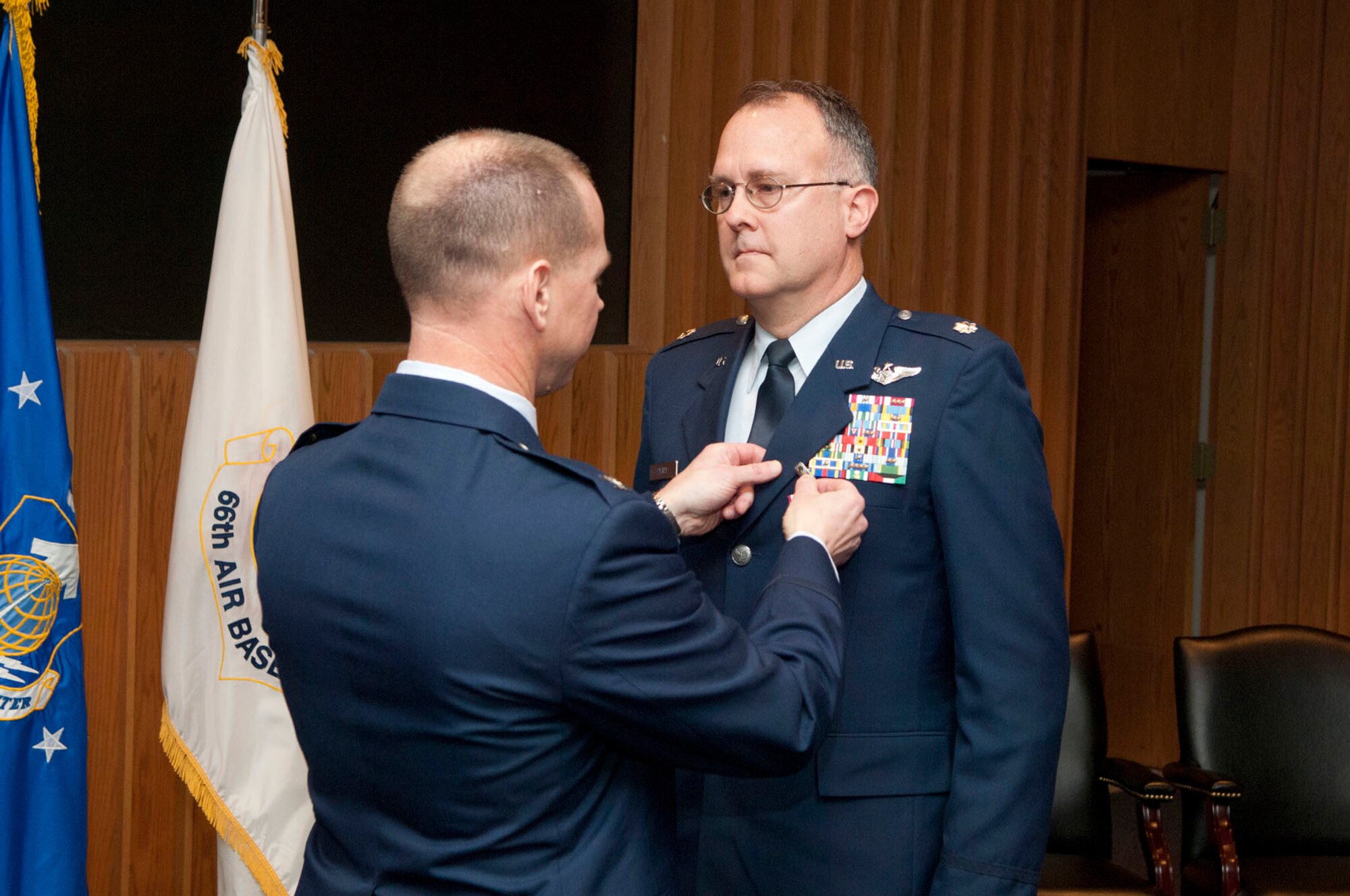 HANSCOM AIR FORCE BASE, Mass. – Col. David W. Hiltz, Aerial Ground Surveillance Division chief (left), pins a medal on Lt. Col. Scott D. Pierce, 66th Air Base Group Inspector General, during his retirement ceremony Jan. 31. Pierce retired after 25 years of service. (U.S. Air Force photo by Mark Wyatt)