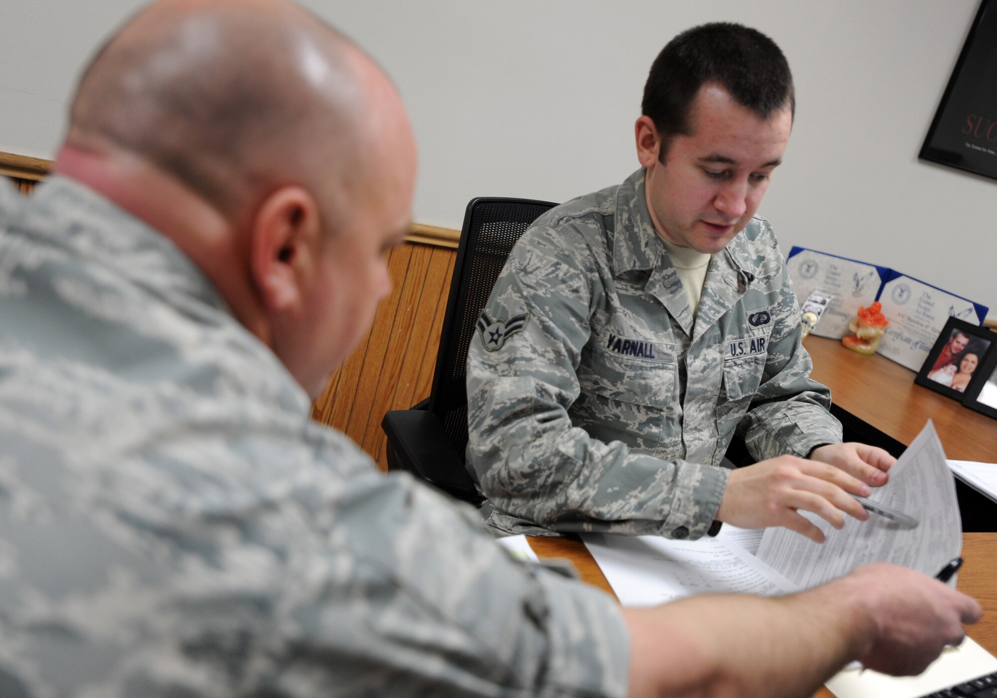 MINOT AIR FORCE BASE, N.D. -- Airman 1st Class Matthew Yarnall, 5th Comptroller Squadron customer service technician, seen here providing assistance to a customer, was one of several Airmen who were instrumental in the squadron's achievement in earning the 2011 U.S. Air Force Special Acts and Services Award. The Air Force-level award recognized the 5th CPTS's efforts in providing crucial support to displaced Airmen and their families, during last summer's historic Souris River Flood. (U.S. Air Force photo/Senior Airman Jose L. Hernandez)

