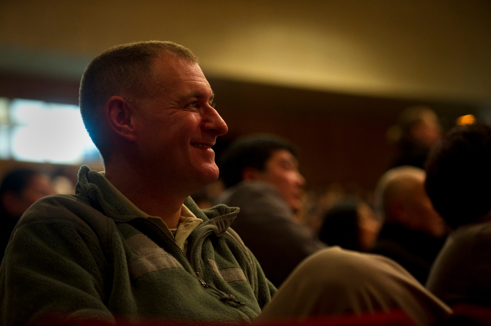 Master Sgt. Gary Noel, "Afterburner" guitarist, enjoys performances during an American song contest at the Seitek Youth Center in Bishkek, Kyrgyzstan, Jan. 31, 2012. The members of Afterburner are deployed from Hanscom Air Force Base, Mass., and are visiting Kyrgyzstan for a nine-day tour. The American song contest was a celebration sponsored by the U.S. Embassy honoring the 20-year friendship between the U.S. and Kyrgyz Republic. (U.S. Air Force photo by Staff Sgt. David Salanitri/Released)