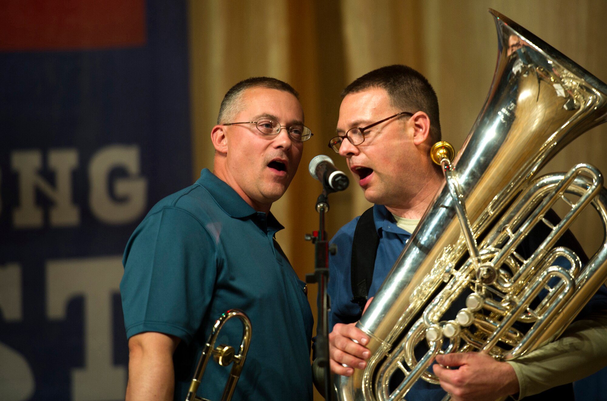 Staff Sgt. William Harris (left), "Afterburner" trombone player, and Airman 1st Class Adam Porter (right), Afterburner tuba player, harmonize during a song for a crowd of people at the Seitek Youth Center in Bishkek, Kyrgyzstan, Jan. 31, 2012. The band is a group of United States Air Force members deployed from Hanscom Air Force Base, Mass. (U.S. Air Force photo/Staff Sgt. David Salanitri)