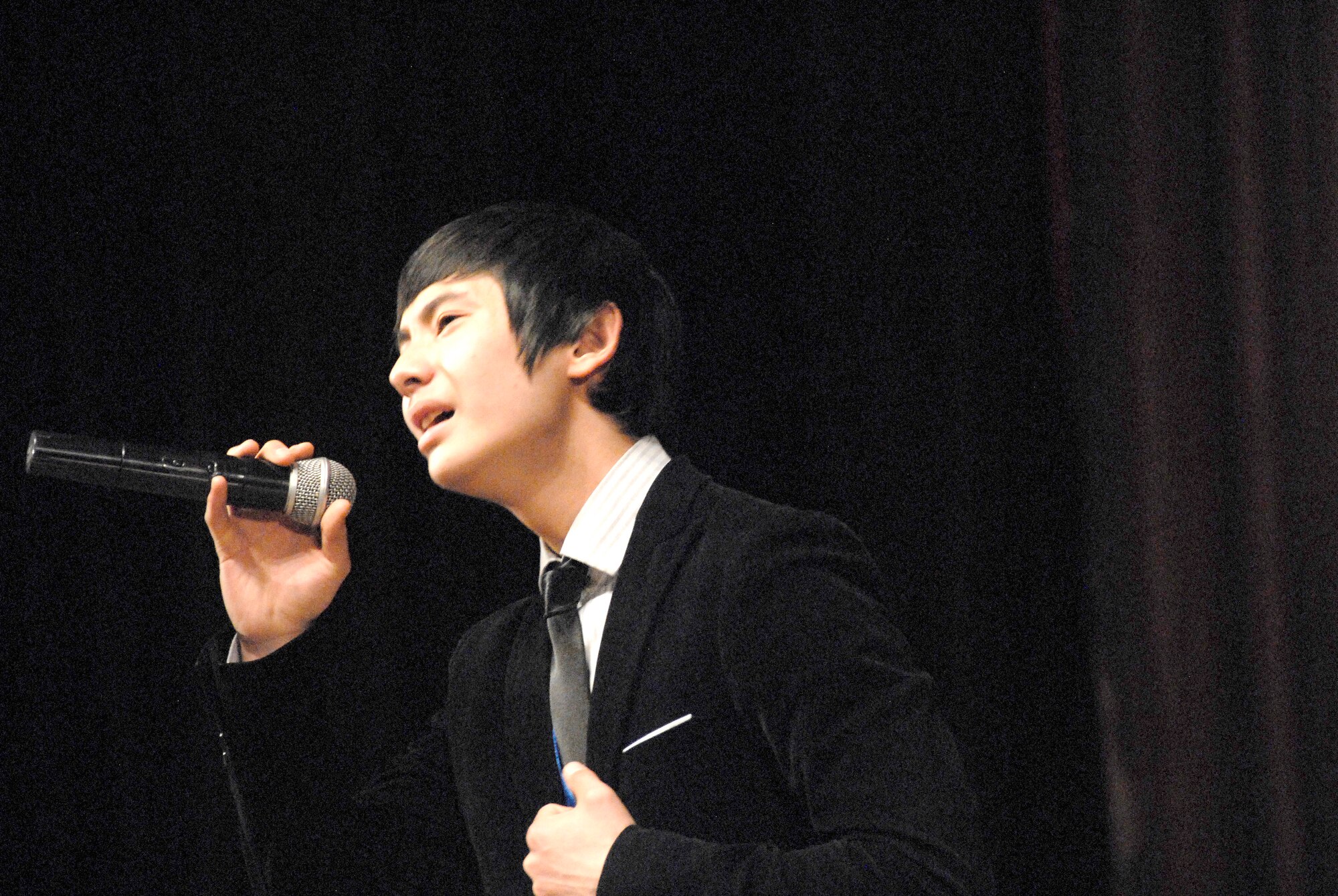 Kazakov Bekten, a student from School #68, performs "How Long" by Lionel Richie at the Seitek Youth Center in Bishkek, Kyrgyzstan, Jan. 31, 2012. Children from area schools competed in an American song contest performing songs by artists like Selena Gomez, Britney Spears and Michael Jackson. The contest was a celebration of 20 years of friendship between the U.S.  and Kyrgyz Republic. (U.S. Air Force photo/Senior Airman Lynsie Nichols)