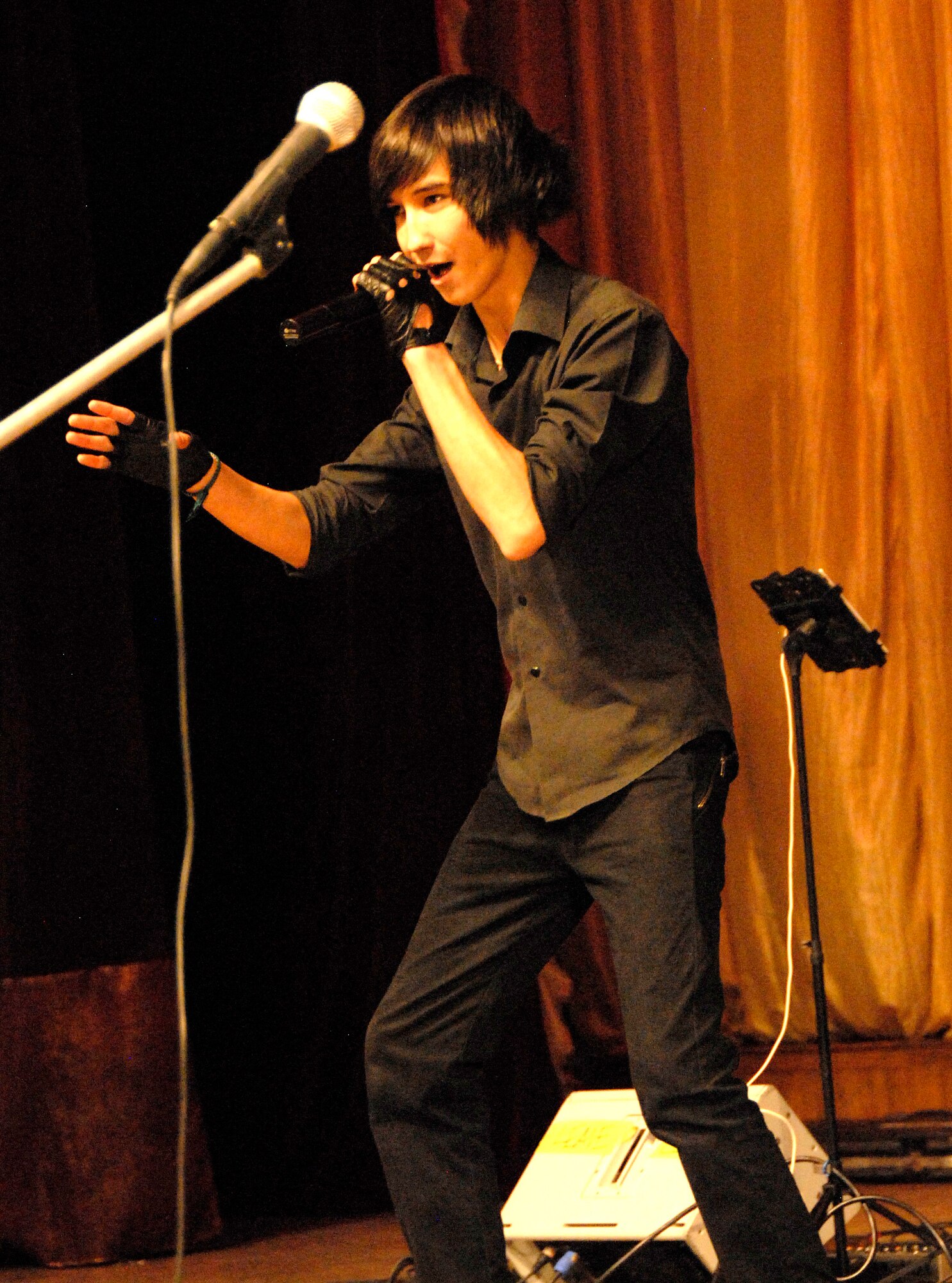 Hairetdinov Daulet, a student from School #52, performs ?Beautiful Lie? by 30 Seconds to Mars for a crowd of people at the Seitek Youth Center in Bishkek, Kyrgyzstan, Jan. 31, 2012. Daulet competed with other students at his school before being chosen to compete in the American song contest. (U.S. Air Force photo/Senior Airman Lynsie Nichols)