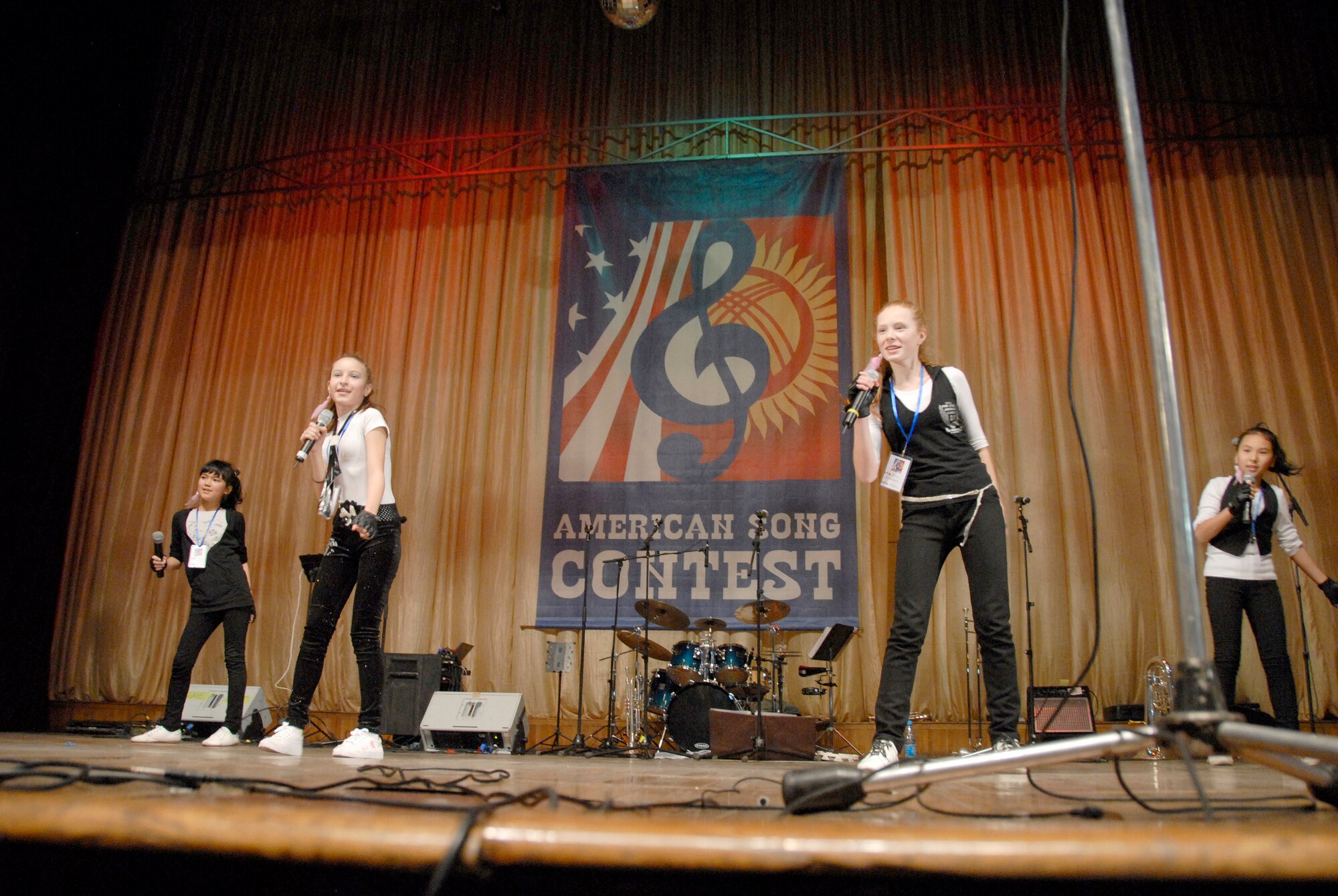 A quartet from School Taalim performs ?Till the World Ends? by Britney Spears for a crowd of people at the Seitek Youth Center in Bishkek, Kyrgyzstan, Jan. 31, 2012. Children from area schools competed for first place during an American song contest sponsored by the U.S. Embassy to celebrate 20 years of friendship between the United States and Kyrgyz Republic. (U.S. Air Force photo/Senior Airman Lynsie Nichols)