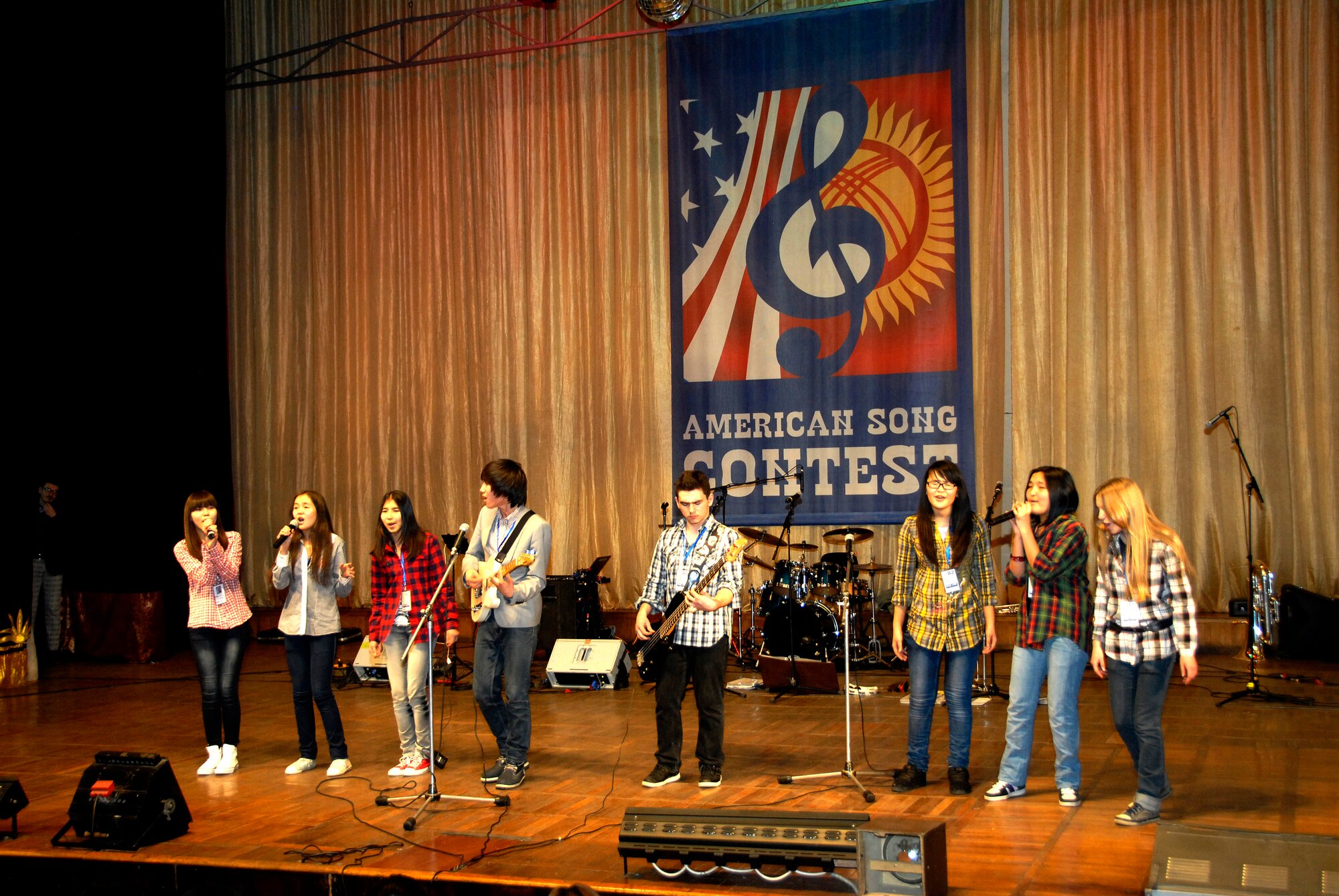 Eight teens from School #12 perform ?The Lazy Song? by Bruno Mars for a crowd of people at the Seitek Youth Center in Bishkek, Kyrgyzstan, Jan. 31, 2012. Children from area schools competed in an American song contest sponsored by the U.S. Embassy to celebrate the 20-year friendship between the U.S. and Kyrgyz Republic. (U.S. Air Force photo/Senior Airman Lynsie Nichols)