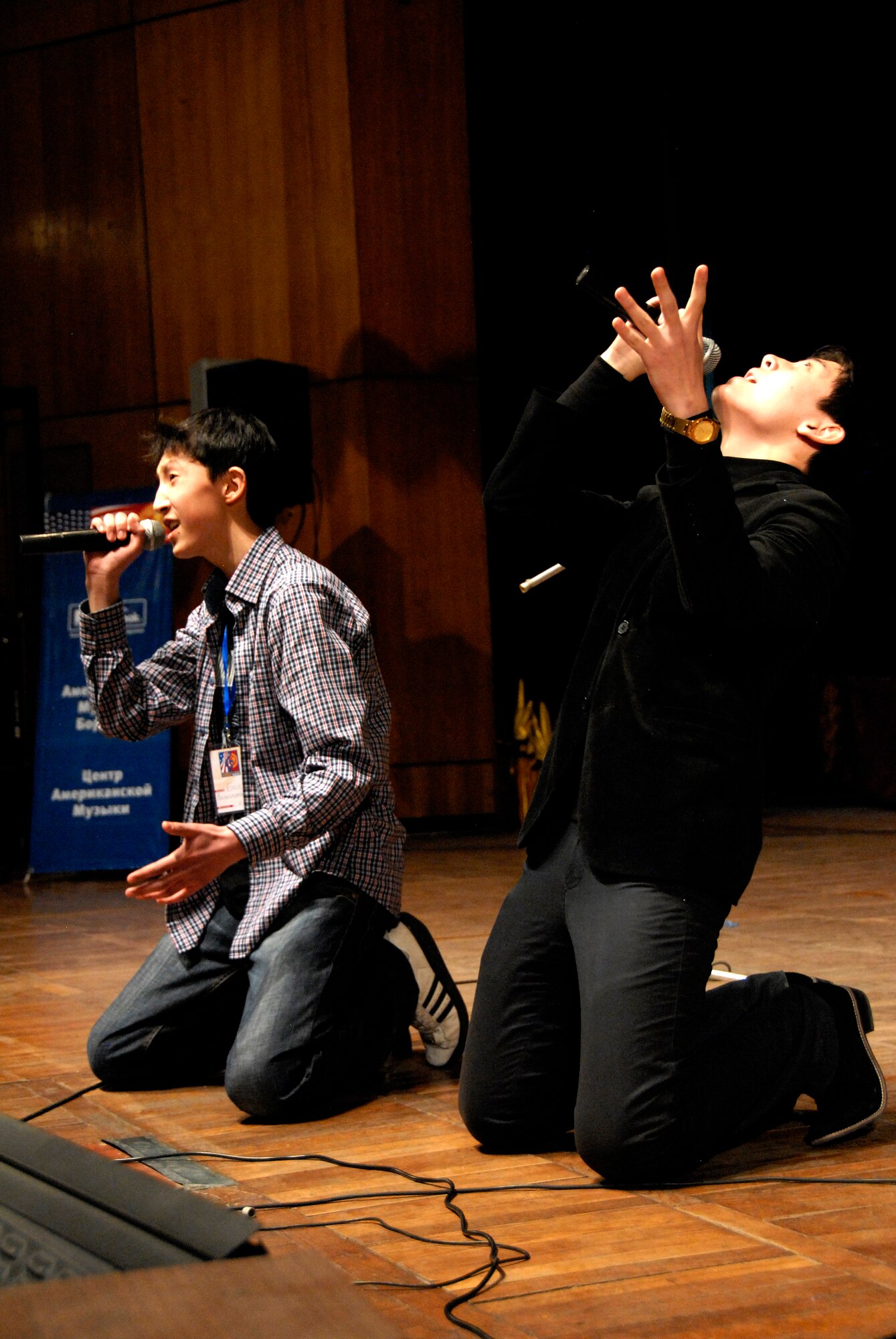 A duet from School #61 performs ?It Will Rain? by Bruno Mars at the Seitek Youth Center in Bishkek, Kyrgyzstan, Jan. 31, 2012. Children from area schools competed in a song contest performing songs by popular American singers. (U.S. Air Force photo/Senior Airman Lynsie Nichols)