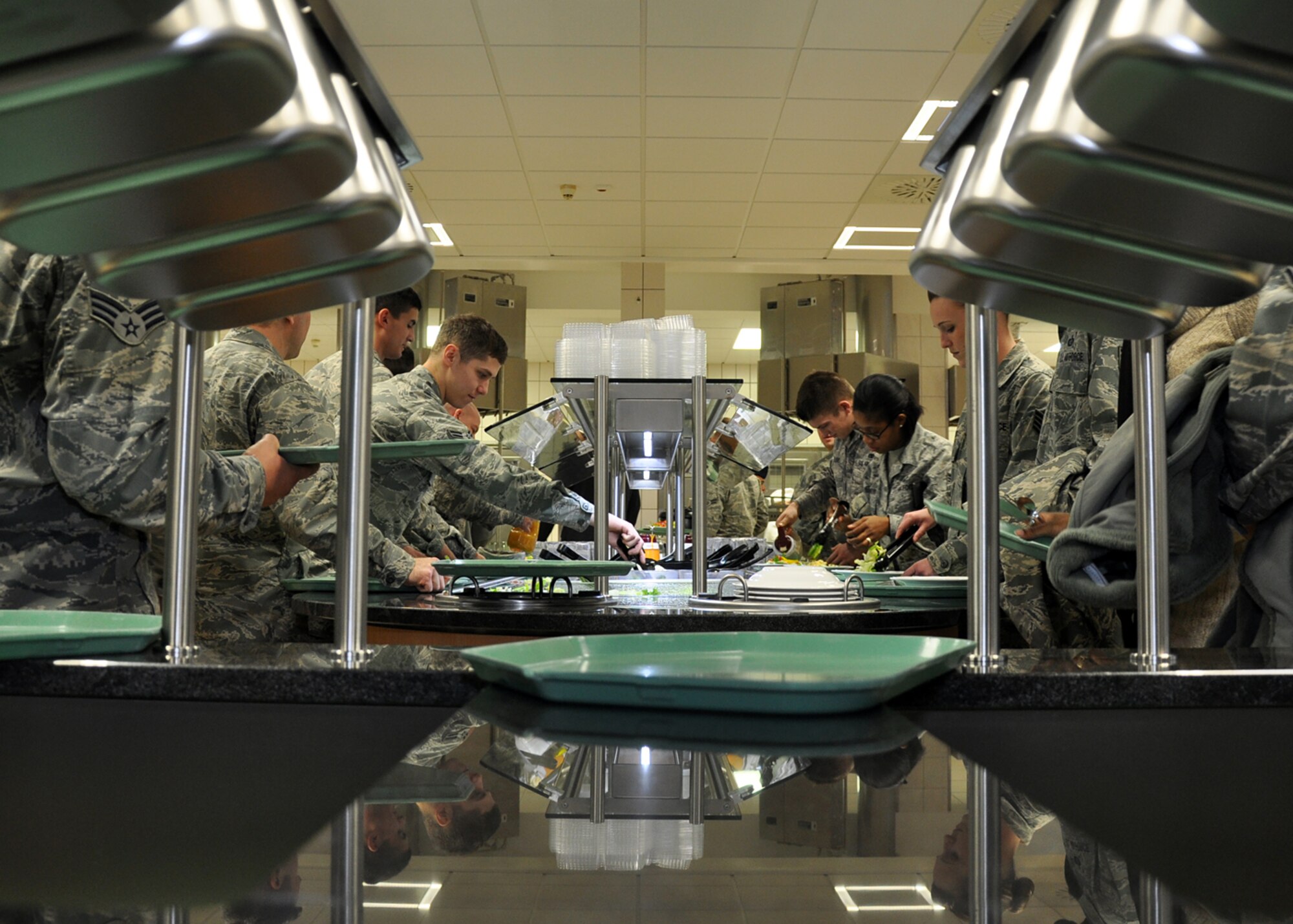 SPANGDAHLEM AIR BASE, Germany – Airmen pick up lunch trays and cutlery before proceeding to the serving line at the Mosel Dining Facility here after the facility’s re-opening ceremony Feb. 1. The building closed in August 2010 for renovations to the cold-storage space, and base engineers used the facility’s closure time to upgrade the serving line, foot-traffic pattern and seating area. The new appearance is designed to make meal times more efficient for DFAC customers. (U.S. Air Force photo/Staff Sgt. Daryl Knee)