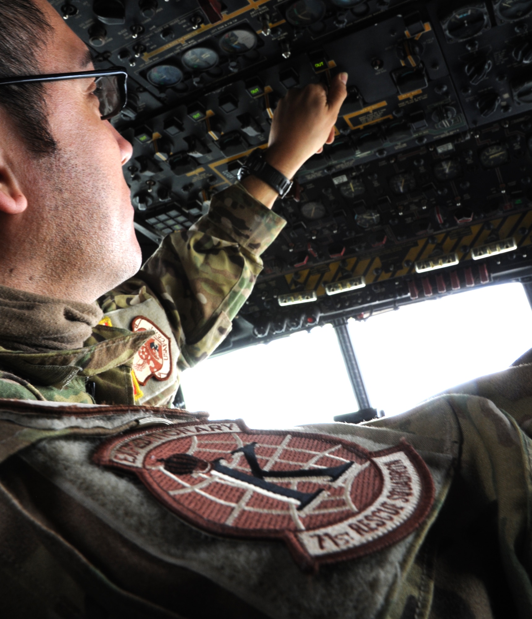 CAMP BASTION, Afghanistan -- Master Sgt. Rogelio Martinez, 76th Expeditionary Rescue Squadron flight engineer, hits switches on the control panel of a HC-130P King. As the flight engineer, Martinez plays a vital role in the only fixed wing medical evacuation missions flown for Operation ENDURING FREEDOM.  (U.S. Air Force photo/Tech. Sgt. Beth Del Vecchio)
