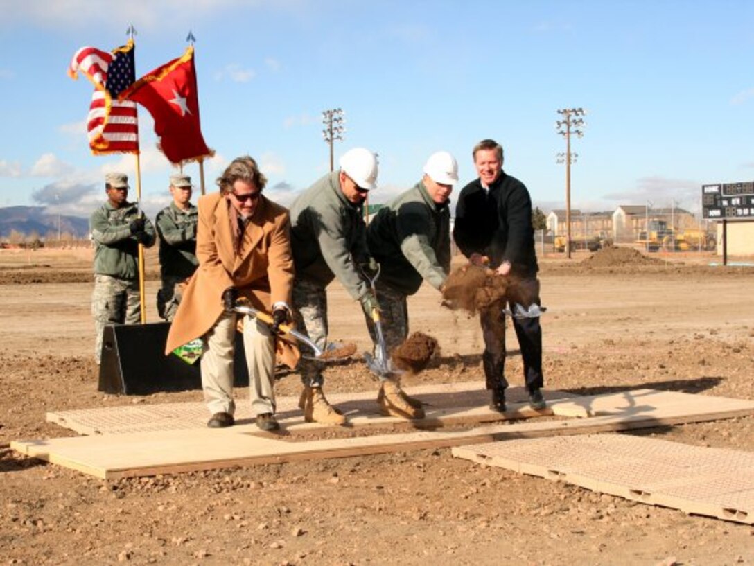 FORT CARSON, Colo. — (From left) Matthew Ellis, U.S. Army Corps of Engineers, Omaha District; Maj. Gen. Joseph Anderson, commanding general, 4th Infantry Division and Fort Carson; Col. Robert F. McLaughlin, garrison commander; and Monte Larsen, chief operations officer of the Native American Services Corp; scoop the ceremonial first shovel of dirt at the Jan. 27, 2012 groundbreaking of the Mission Command Training Center.