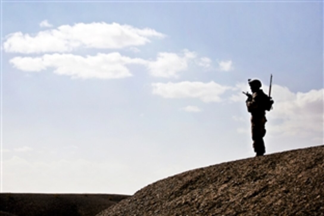 U.S. Marine Lance Cpl. Cody Varnell watches from a hill during a security patrol with Afghan Border Police in Helmand province, Afghanistan, Jan. 30, 2012. Varnell is a machine gunner assigned to Weapons Company, 3rd Battalion, 3rd Marine Regiment. In the southern Garmsir district, an area with a history of tribal conflict, the growing Afghan force has deepened its roots and established governance through Marine mentors.