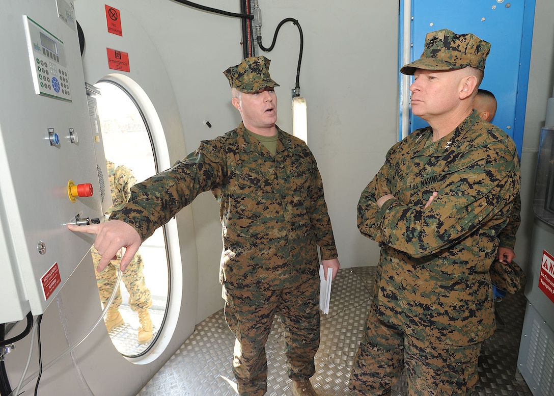Captain Benjamin Mencke, energy officer, Public Works, Marine Corps Logistics Base Barstow, explains to Maj. Gen. James A. Kessler, Commanding General Marine Corps Installations Command, the control system of the wind turbine on MCLB Barstow, Feb. 2.