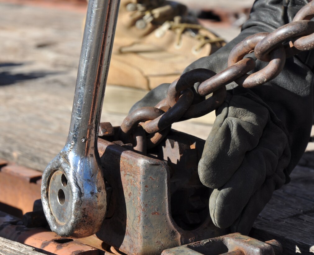 Sgt. Kevin Myers, a landing support specialist with Landing Support Company, Combat Logistics Regiment 17, 1st Marine Logistics Group, tightens a metal chain during an exercise held at the railhead on Marine Corps Logistics Base Barstow, Feb. 2.