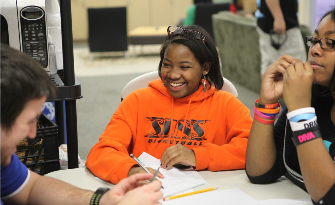 Shantrell Shae Burke, the recipient of Teen of the Month for January, laughs as she works on homework at Teen Squad at the Midway Park Community Center Feb. 3. Teen of the month is awarded through Teen Squad an after school program for teenagers aboard Marine Corps Base Camp Lejeune. Burke is an athlete and enjoys the outdoors.