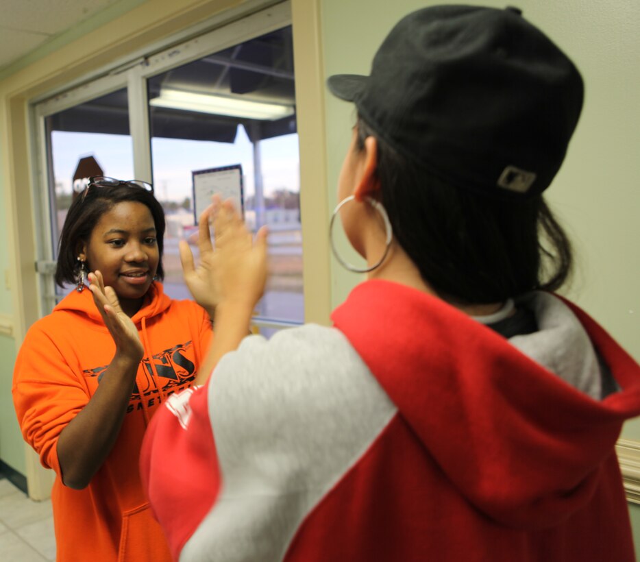 Shantrell Shae Burke, the recipient of Teen of the Month for January, plays with her best friend during Teen Squad at the Midway Park Community Center Feb. 3. Burke is very close to her friends and family and credits her family for her successes.