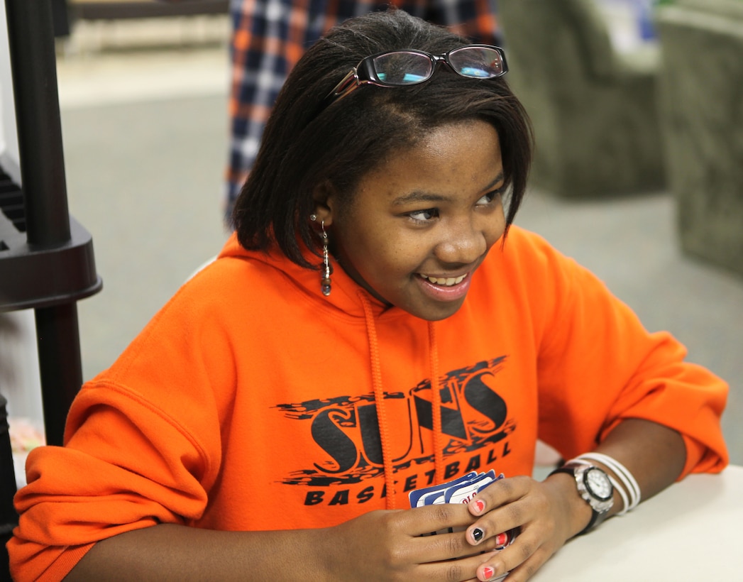 Shantrell Shae Burke, the recipient of Teen of the Month for January, plays cards with her friends at Teen Squad at the Midway Park Community Center Feb. 3. Burke enjoys volunteering, even if it's for unpopular projects. She feels that even if she only helps a little bit, volunteering could still greatly affect a person.