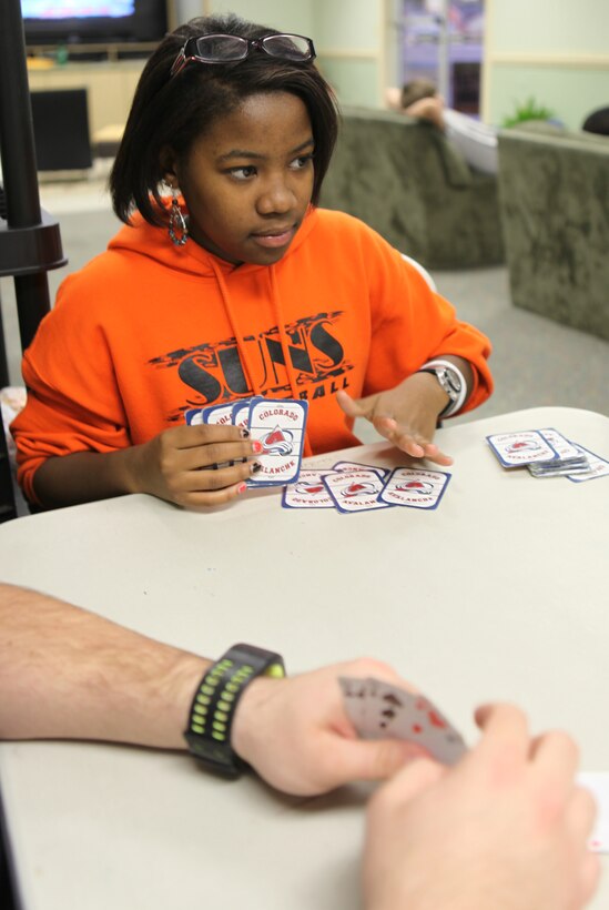 Shantrell Shae Burke, the recipient of Teen of the Month for January, tries to hint that she has the winning cards to her partner while she plays cards at Teen Squad at the Midway Park Community Center Feb. 3. Burke is from Swainsboro, Georgia, a place with wide open places she visits during holidays and summers to see her relatives.