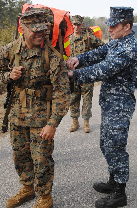 A Navy corpsman ensures a Marine has an ample supply of water during a 14-mile hike around MCLB?Albany, Feb. 3.