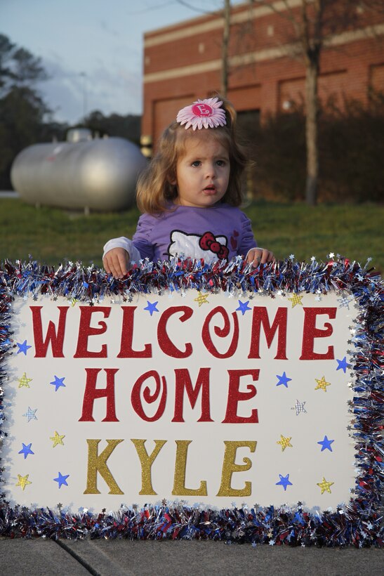 Emalyne Brown, 2, holds a sign while she waits for her father, Cpl. Richard K. Brown, an aircraft electronic countermeasures systems technician with Marine Aviation Logistics Squadron 14, to return Feb. 4, 2012. Brown is returning back to his family after being on a 7-month deployment to Camp Bastion, Afghanistan in support of Operation Enduring Freedom.::r::::n::::r::::n::