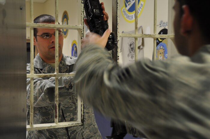 Staff Sgt. James Cosens, 9th Security Forces Squadron noncommissioned officer in charge of the armory, turns in a cleared M-4 rifle to an armorer at Beale Air Force Base, Calif., Feb. 1, 2012. Every weapon is checked at least twice for safety requirements before it is turned into the armory. (U.S. Air Force photo by Staff Sgt. Robert M. Trujillo) 