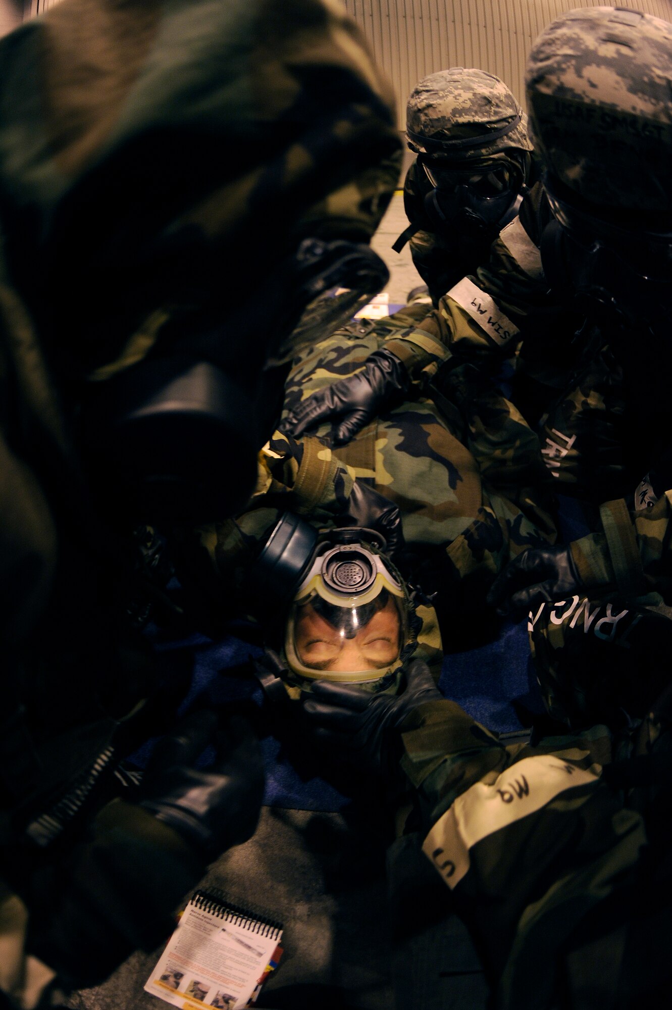 U.S. Air Force Senior Airman Kurt Saine, 354th Comptroller Squadron budget analyst, simulates chemical injuries as wingmen put Self Aid-Buddy Care skills to the test during Ability to Survive and Operate training Feb. 1, 2012, at Eielson Air Force Base, Alaska. ATSO training allowed Airmen to sharpen their combat life saving techniques through various biological and chemical attack scenarios.  (U.S. Air Force photo by Staff Sgt. Jim Araos/Released)