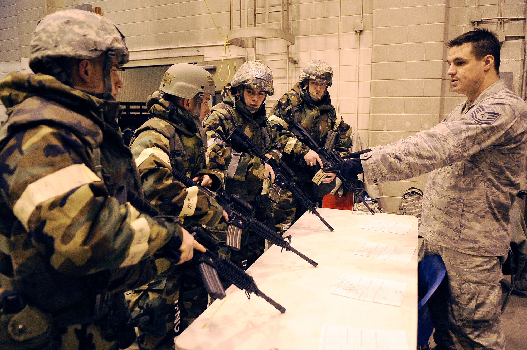 U.S. Air Force Tech. Sgt. Tommy Nelson, 354th Security Forces Squadron combat arms instructor, train Airmen on the use of the M4 carbine during Ability to Survive and Operate training Feb. 1, 2012, at Eielson Air Force Base, Alaska. Nelson instructed weapon clearing, loading and remedial actions. (U.S. Air Force photo by Staff Sgt. Jim Araos/Released)