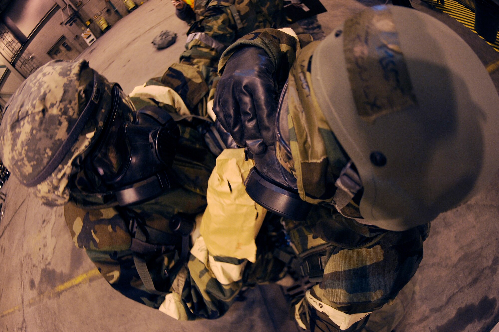 U.S. Air Force Maj. Michael Dye, 354th Logistics Readiness Squadron commander, decontaminates U.S. Air Force Master Sgt. Corey Proulx, 354th LRS first sergeant, during Ability to Survive and Operate training Feb. 1, 2012, at Eielson Air Force Base, Alaska. The decontamination portion of the training allowed Airmen to perform procedures for safely drinking from a canteen while in a chemical environment. (U.S. Air Force photo by Staff Sgt. Jim Araos/Released)