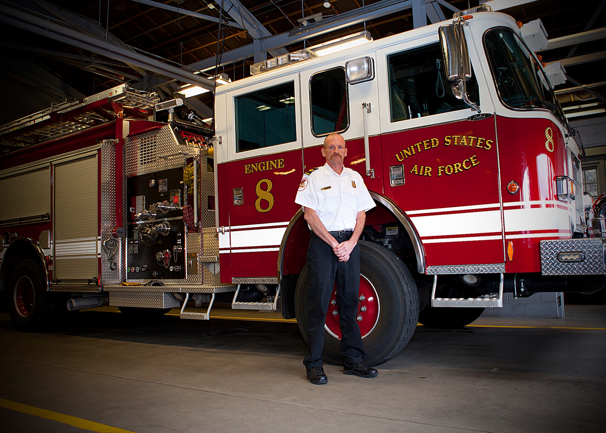 Greg Chesser, 90th Civil Engineer Squadron assistant fire chief for fire prevention, poses for a photo next to engine eight in Warren’s fire department Jan. 30. (U.S. Air Force photo by Matt Bilden)