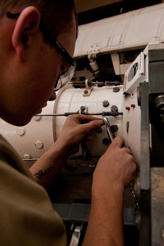 Airman 1st Class Joshua Breeding, 28th Munitions Squadron armament systems apprentice, safety-wires a bolt on a Conventional Rotary Launcher in the armament shop at Ellsworth Air Force Base, S.D., Jan. 26, 2012. CRLs are used to carry either eight, ten or 24 munitions in B-1Bs which in return help protect and save American lives. (U.S. Air Force photo by Airman 1st Class Kate Thornton/Released)