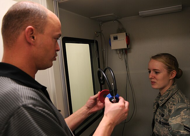 Joe Cacciatore, 9th Aerospace Medicine Squadron physical health civilian, conducts an occupational health exam for Airman 1st Class Ayla Quellhorst, a Beale Air Force member at Public Health at Beale Air Force Base, Calif., Jan. 31, 2012. Cacciatore performs health exams for people who work around hazardous noise above 85 decibels and hazardous chemicals. (U.S. Air Force photo by Airman 1st Class Brittany Paerschke-O'Brien/ Released)