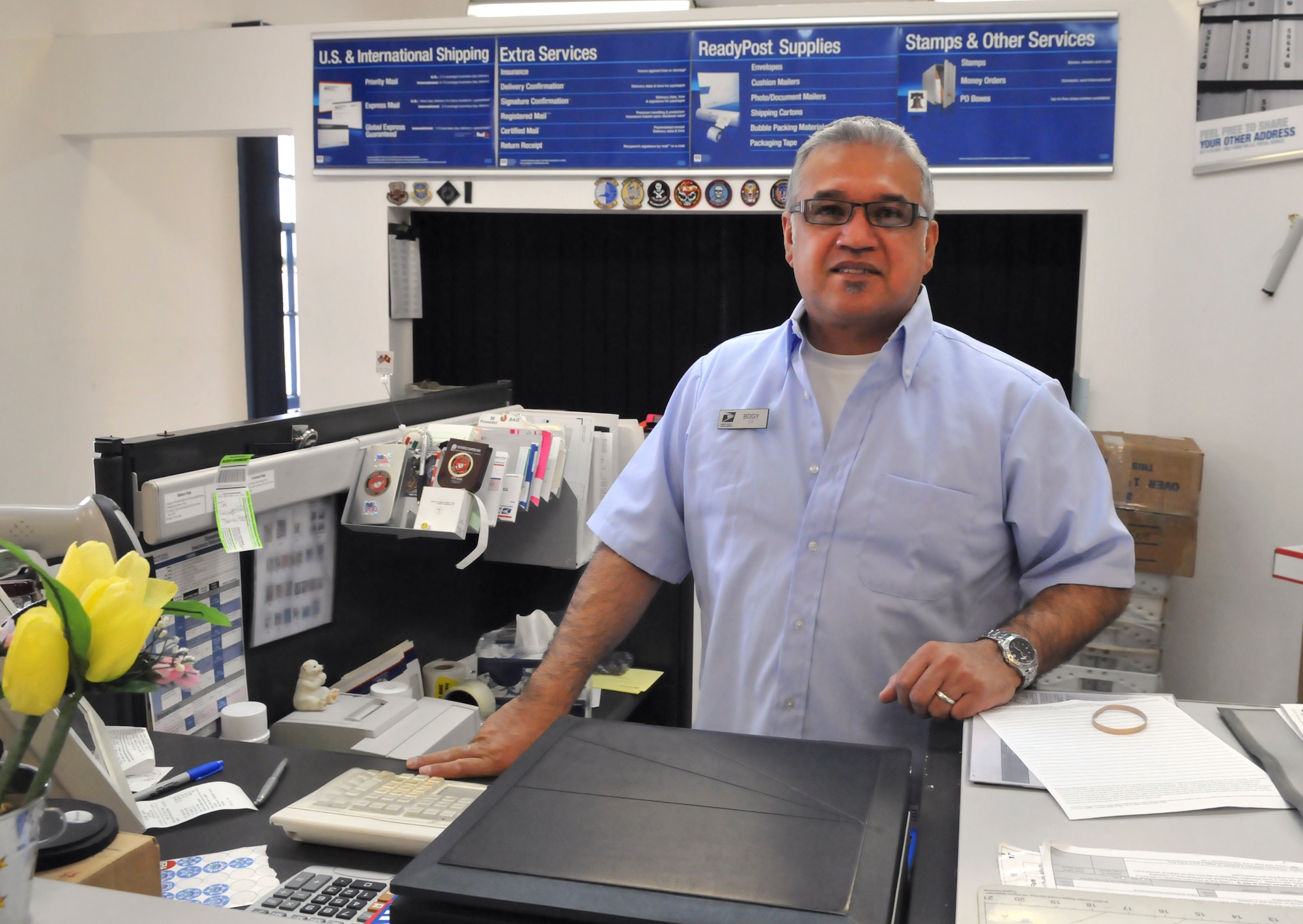 Lawrence Bogy, U.S. Postal Service window technician, mans the window in the F. E. Warren Air Force Base, Wyo., post office Jan. 30. The postal service held a town hall meeting Jan. 25 to discuss the possible closing of the base post office. (U.S. Air Force photo by R.J. Oriez)