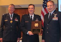 Master Sgt. Rich Bonnicelli (right) and Lt. Col. Joe Cautero (center) accept the Marchbanks Award for Aerial Achievement from Col. Williams. (USAF photo courtesy of 916 OG)