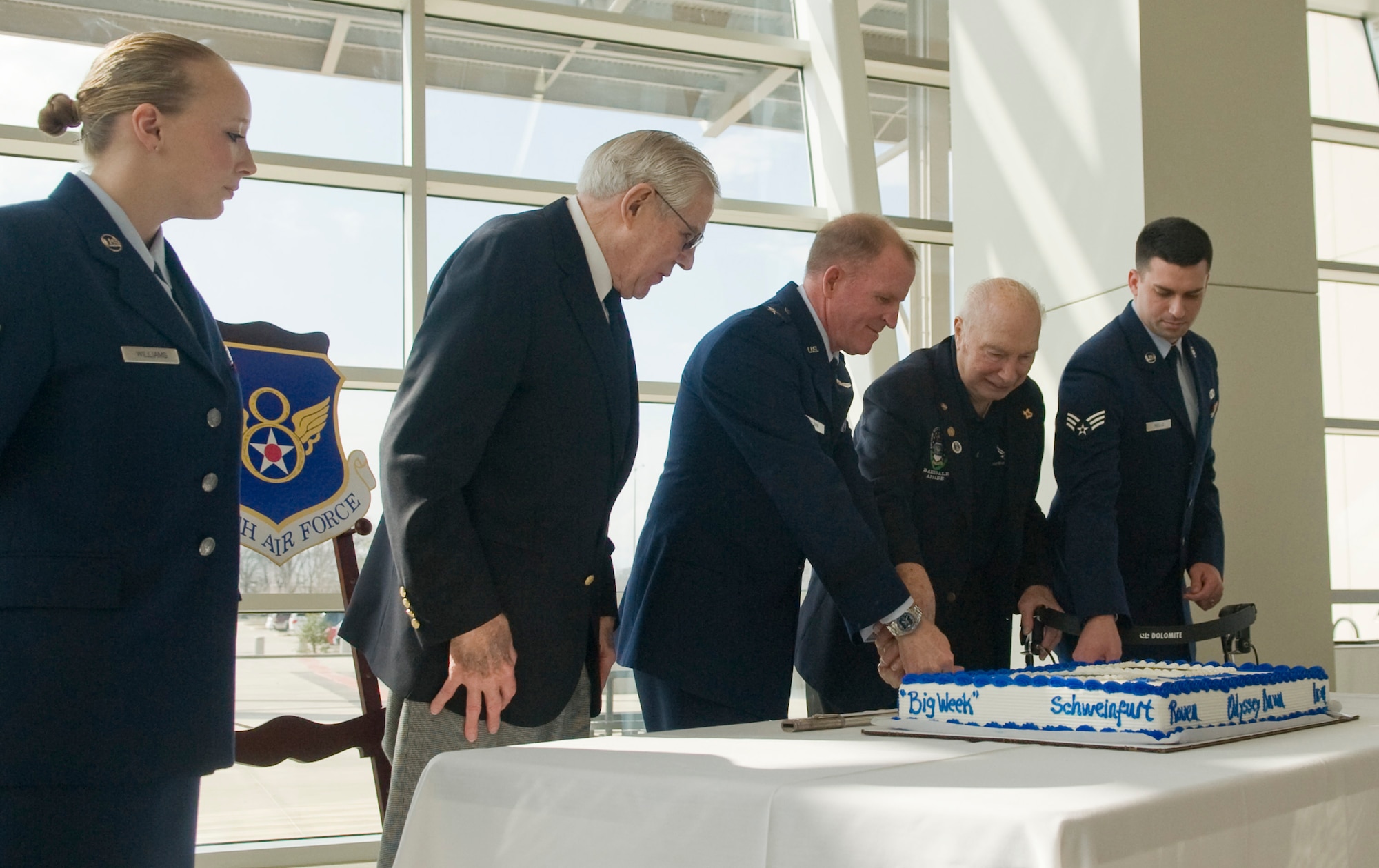 Bossier City, La. -- Maj. Gen. Stephen Wilson, 8th Air Force commander, retired Col. Steve dePyssler, alumni of 8th Bomber Command and Senior Airman Adam Wells, the 8th Air Force Airman of the Month cut the cake during the 8th Air Force birthday celebration, as Airman 1st Class Amanda Williams, the youngest Airman of the Mighty Eighth and former unit commander retired Lt. Gen. Edgar S. Harris Jr. look on at the Cyber Innovation Center in Bossier City, La., Feb. 1.  The milestone marks the 70th year the 8th Air Force has been active. (U.S. Air Force photo/Senior Airman Kristin High)(RELEASED) 