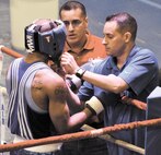 Air Force boxing coach Steven Franco and assistant coach Bobby DeLeon prepare Markarious Gordon for a bout during the Air Force Box-Offs. (Photo by/Deyanira Romo Rossell)