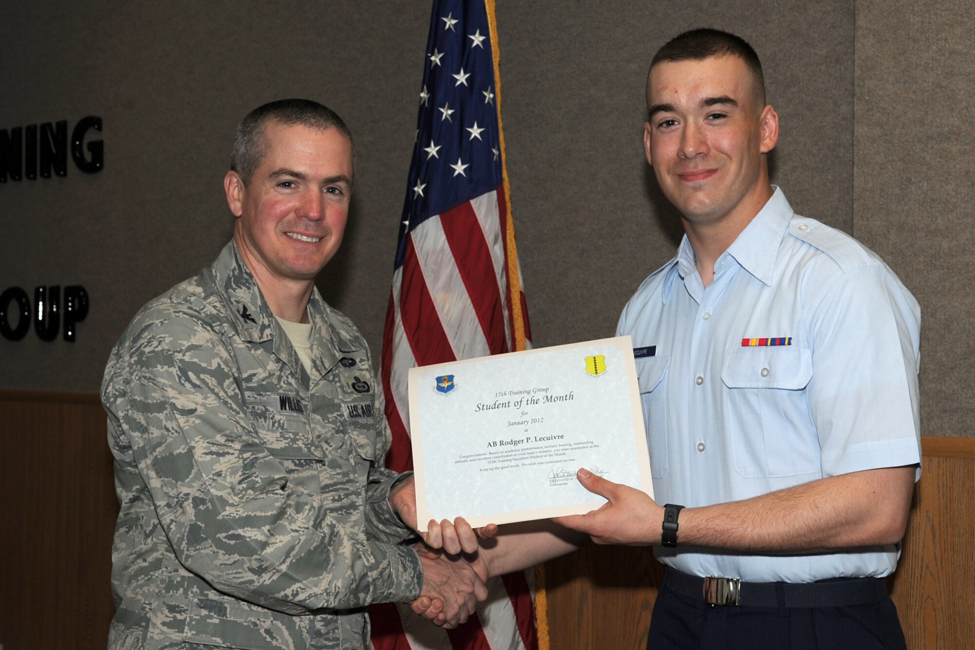 GOODFELLOW AIR FORCE BASE, Texas -- Col. JD Willis, 17th Training Group Commander, presents Airman Rodger Lecuivre with the 312th Training Squadron Student of the Month award for January, Feb. 3. (U.S. Air Force photo/Staff Sgt. Laura R. McFarlane)