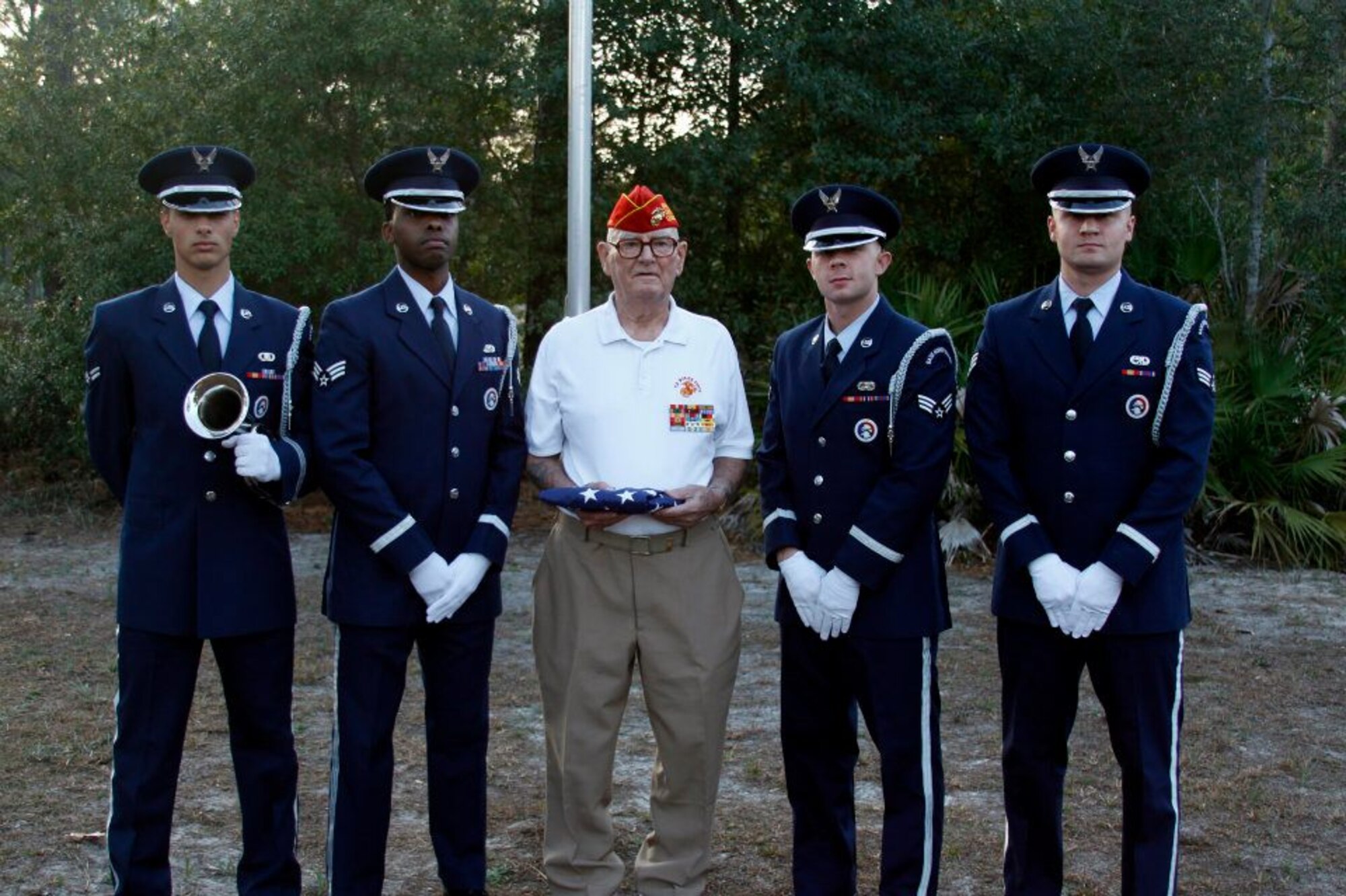 Retired U.S. Marine Corps Master Gunnery Sgt. Jay DeGraw, center, poses with (from left to right) Airman 1st Class Lionel Delgado-Perez, Senior Airmen Mario Super, Steven McCormick and Michael Brooks, members of the Hurlburt Field Honor Guard, after completing a retreat ceremony at his residence in Navarre, Fla., Jan. 31, 2012. DeGraw requested the Airmen perform the ceremony on his final day at his home before moving into a retirement community. (U.S. Air Force photo by Senior Airman Steven Dieterle) (Released)