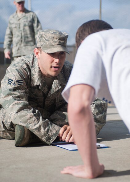 U.S. Air Force Senior Airman Joseph Gormany, 336th Recruiting Squadron enlisted accessions recruiter, encourages a recruit to do more pushups during the physical ability and stamina test (PAST) at Moody Air Force Base, Ga., Jan 27, 2012. Last year, the 336th RCS recruited 85 Battlefield Airmen. (U.S. Air Force photo by Airman 1st Class Jarrod Grammel/Released)
