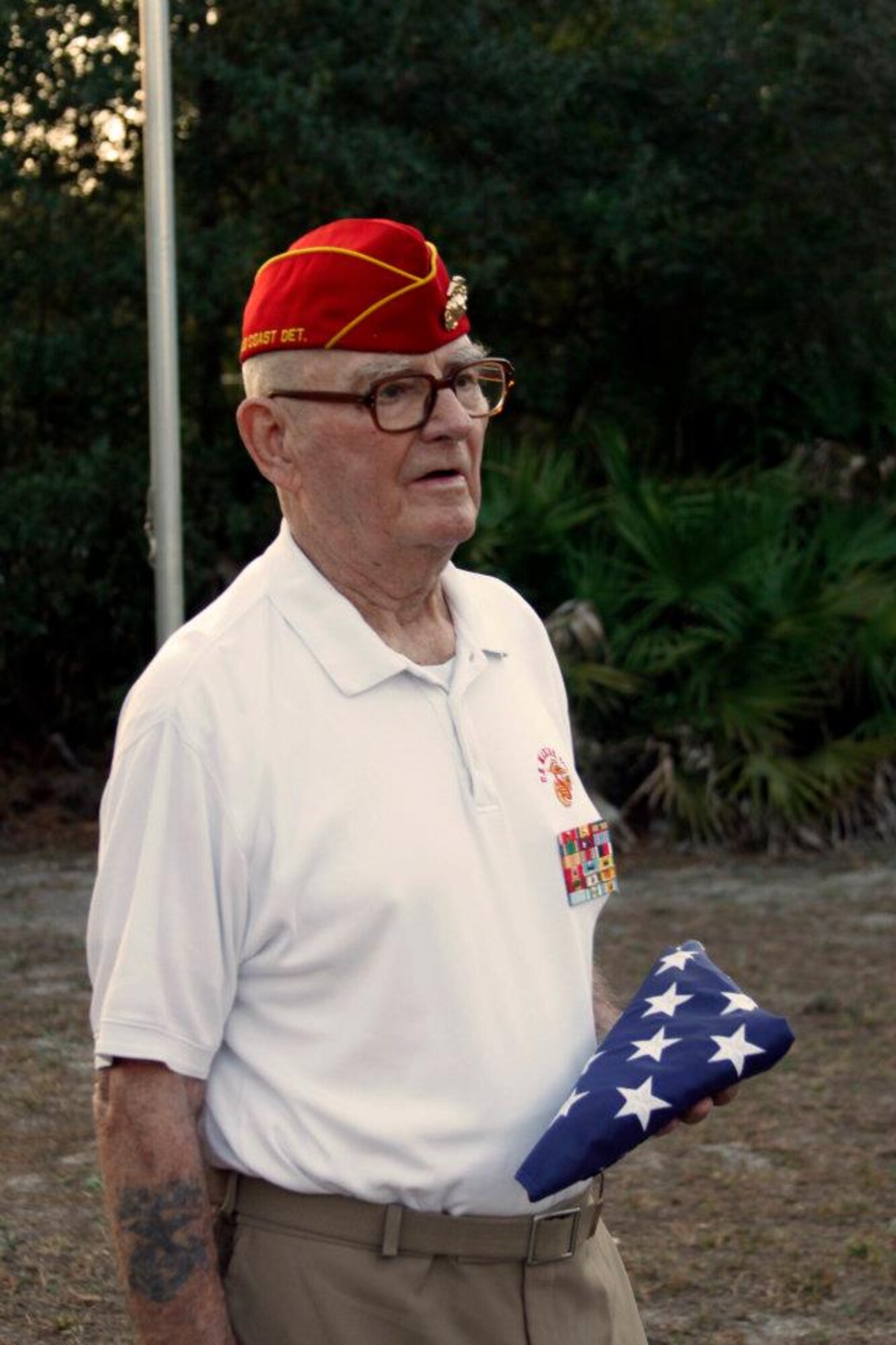 Retired U.S. Marine Corps Master Gunnery Sgt. Jay DeGraw holds a folded American flag after a retreat ceremony at his residence in Navarre, Fla., Jan. 31, 2012. DeGraw, who retired in 1969 after completing 26 years of service, requested the Hurlburt Field Honor Guard to carry out the ceremony. (U.S. Air Force photo by Senior Airman Steven Dieterle) (Released)