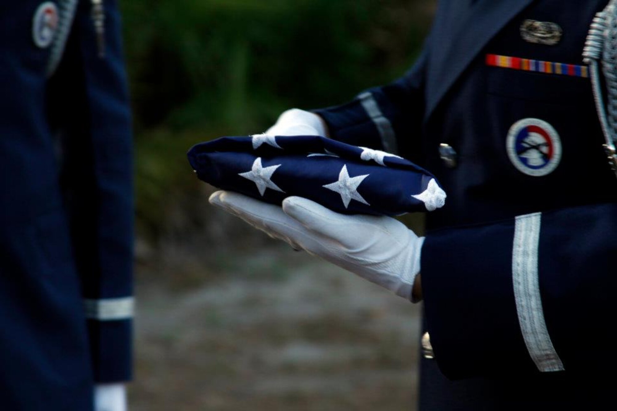 Hurlburt Field Honor Guard Airmen inspect a folded flag during a retreat ceremony in Navarre, Fla., Jan. 31, 2012. The Airmen performed the event at the request of a retired U.S. Marine. (U.S. Air Force photo by Senior Airman Steven Dieterle) (Released)