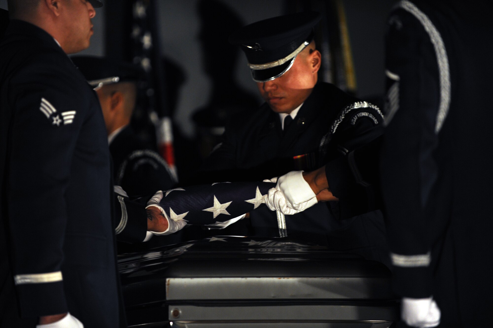 The U.S. Air Force Honor Guard folds Old Glory over a casket during a mock funeral at the 11th Wing Resiliency Day commanders call Jan. 26. Gen. Norton A. 
Schwartz, Air Force Chief of Staff, directed units Air Force-wide to hold a Resiliency Stand Down for their Airmen in the month of January. (U.S. Air 
Force photo/Airman Aaron Stout)
