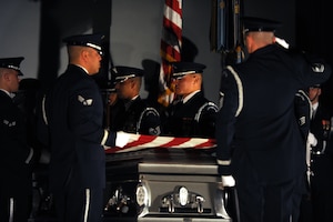 The U.S. Air Force Honor Guard conducts a mock funeral at the base theater during the 11th Wing Resiliency Day commanders call Jan. 26. The presentation was meant to highlight the effects on friends and family left behind after someone commits suicide. (U.S. Air Force photo/Airman Aaron Stout)

