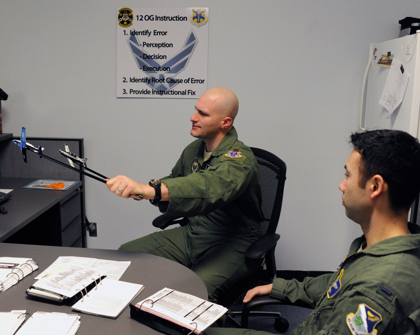 Maj. Stephen Manley (left), 559th Flying Training Squadron instructor pilot, demonstrates flight procedures to 1st Lt. William Dana, 558th FTS instructor candidate.  (U.S. Air Force photo/Don Lindsey)