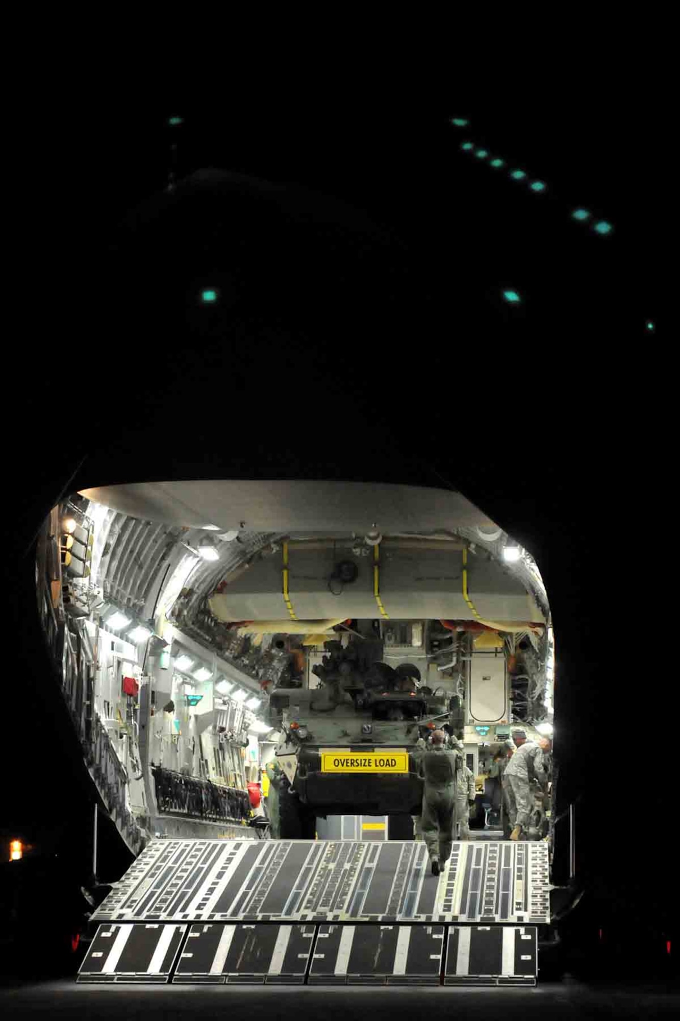 Soldiers from 472nd Signal Company, 4th Stryker Brigade Combat Team, 2nd Infantry Division drive a Stryker vehicle out of an Air Force C-17 Globemaster III aircraft from the 62nd Airlift Wing Jan. 28, 2012, in Moses Lake, Wash. Soldiers of 4th SBCT, 2nd Inf. Div. are participating in Exercise Raider Focus, a monthlong brigade training exercise, and this marks the first time Strykers have been airlifted from JBLM to Yakima. (U.S. Army photo by Spc. Reese Von Rogatsz, 4th SBCT PAO, 2nd Inf. Div.)
