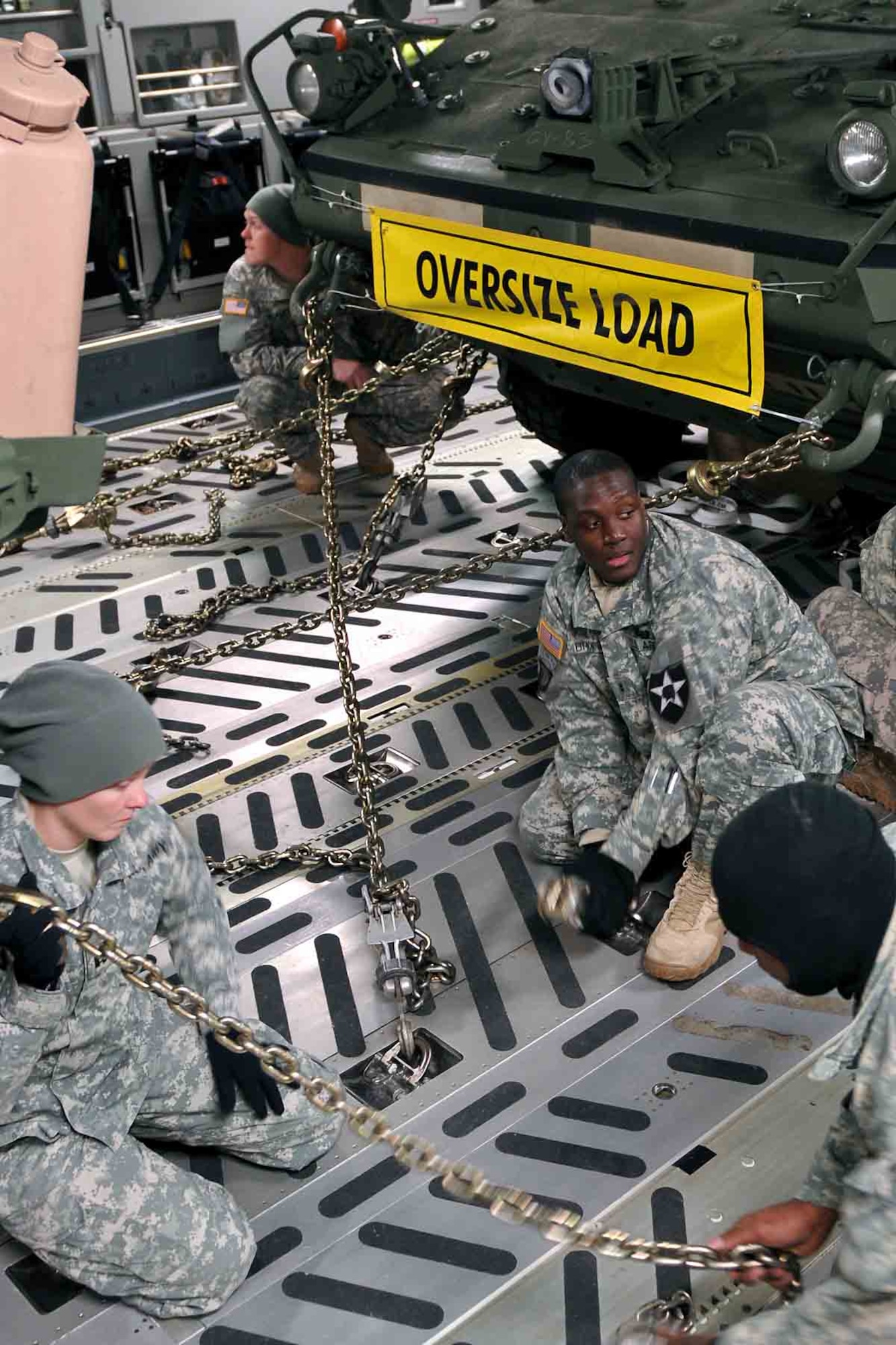 Soldiers from 4th Stryker Brigade Combat Team, 2nd Infantry Division secure their Stryker vehicles in the cargo hold of an Air Force C-17 Globemaster III aircraft from the 62nd Airlift Wing Jan. 28, 2012, at Joint Base Lewis-McChord, Wash. Soldiers of 4th SBCT, 2nd Inf. Div. are participating in Exercise Raider Focus here, a monthlong brigade training exercise, and this marks the first time Strykers have been airlifted from JBLM to Yakima. (U.S. Army photo by Spc. Reese Von Rogatsz, 4th SBCT PAO, 2nd Inf. Div.)