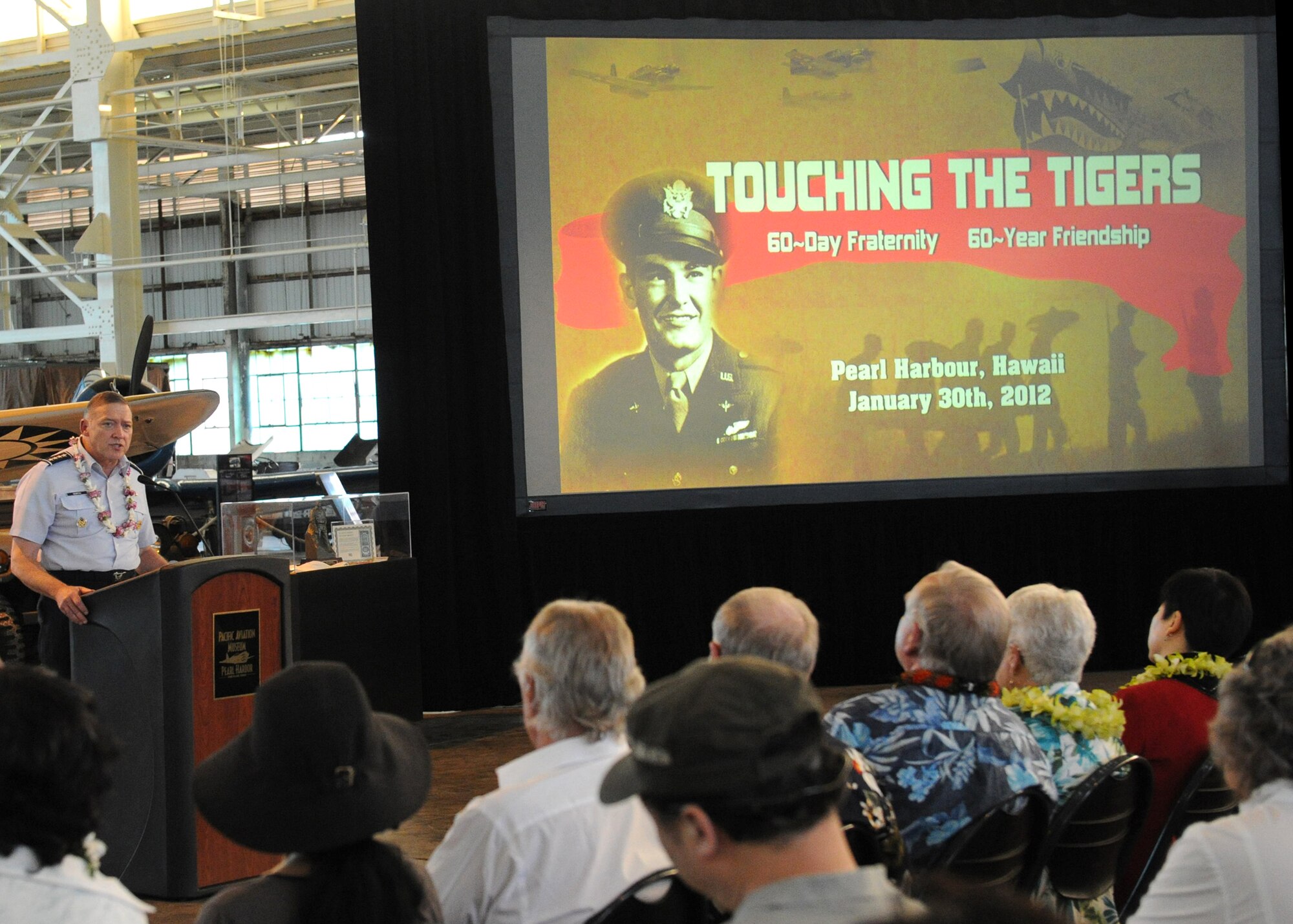 FORD ISLAND, Hawaii--Pacific Air Forces Commander Gen. Gary North speaks to an audience during an event celebrating the legacy of the US-China friendship, held at the Pacific Aviation Museum, Ford Island, Hawaii, Jan. 30, 2012. During the event, the President of the Chinese People’s Association for Friendship with Foreign Countries, Madame Li Xiaolin, presented her film documentary, Touching the Tigers, which tells the story of the late ‘Flying Tigers’ pilot Lt. Glen Beneda. Beneda was a fighter pilot with 14th Air Force, who was shot down and wounded while defending China from Japanese forces during World War II. The documentary also details how Chinese farmers and soldiers helped Beneda escape capture before he was returned to a U.S. air base for medical care. (U.S. Air Force photo/Tech. Sgt. Jerome S. Tayborn/Released)