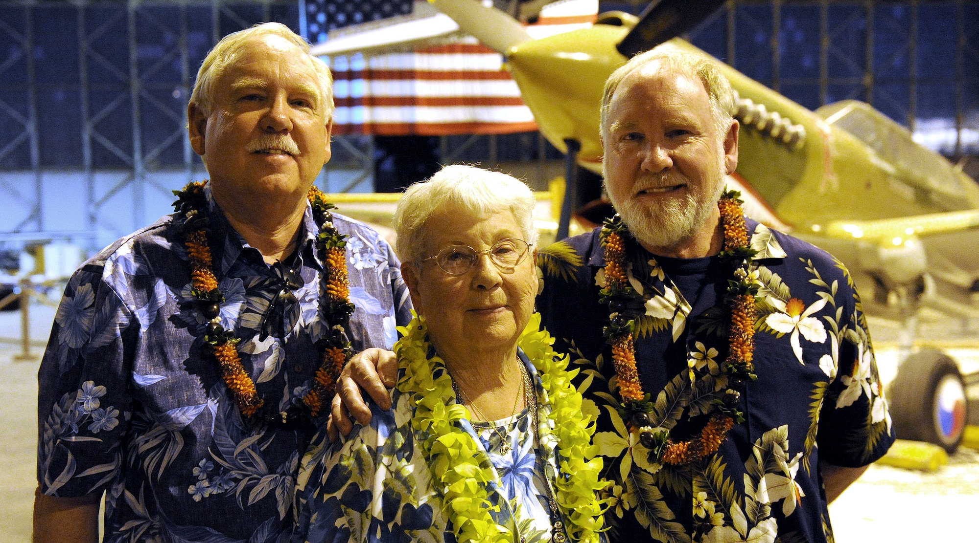 FORD ISLAND, Hawaii--Mrs. Elinor Beneda, spouse of the late Lt. Glen Beneda, a ‘Flying Tigers’ fighter pilot with the 14th Air Force, and her two sons, Edward and Harry Beneda, at an event celebrating the legacy of the U.S.-China friendship, held at the Pacific Aviation Museum, Ford Island, Hawaii, Jan. 30, 2012. During the event, the President of the Chinese People’s Association for Friendship with Foreign Countries, Madame Li Xiaolin, presented her film documentary, Touching the Tigers, which tells the story of Beneda, who was shot down and wounded while defending China from Japanese forces during World War II. The documentary also details how Chinese farmers and soldiers helped Beneda escape capture before he was returned to a U.S. air base for medical care. (U.S. Air Force photo/Tech. Sgt. Jerome S. Tayborn/Released)