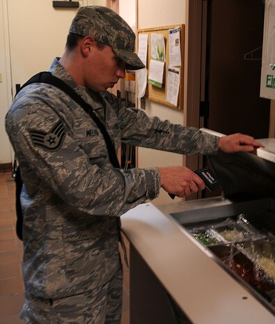 Staff Sergeant Ryan Melvin, 9th Aerospace Medicine Squadron public health technician, inspects the temperature of food at the Recce Point Club lunch bar at Beale Air Force Base, Calif,. Jan. 31, 2012. Melvin uses a laser to ensure that the food is at the appropriate temperature. (U.S. Air Force photo by Airman 1st Class Brittany Paerschke-O'Brien/ Released)