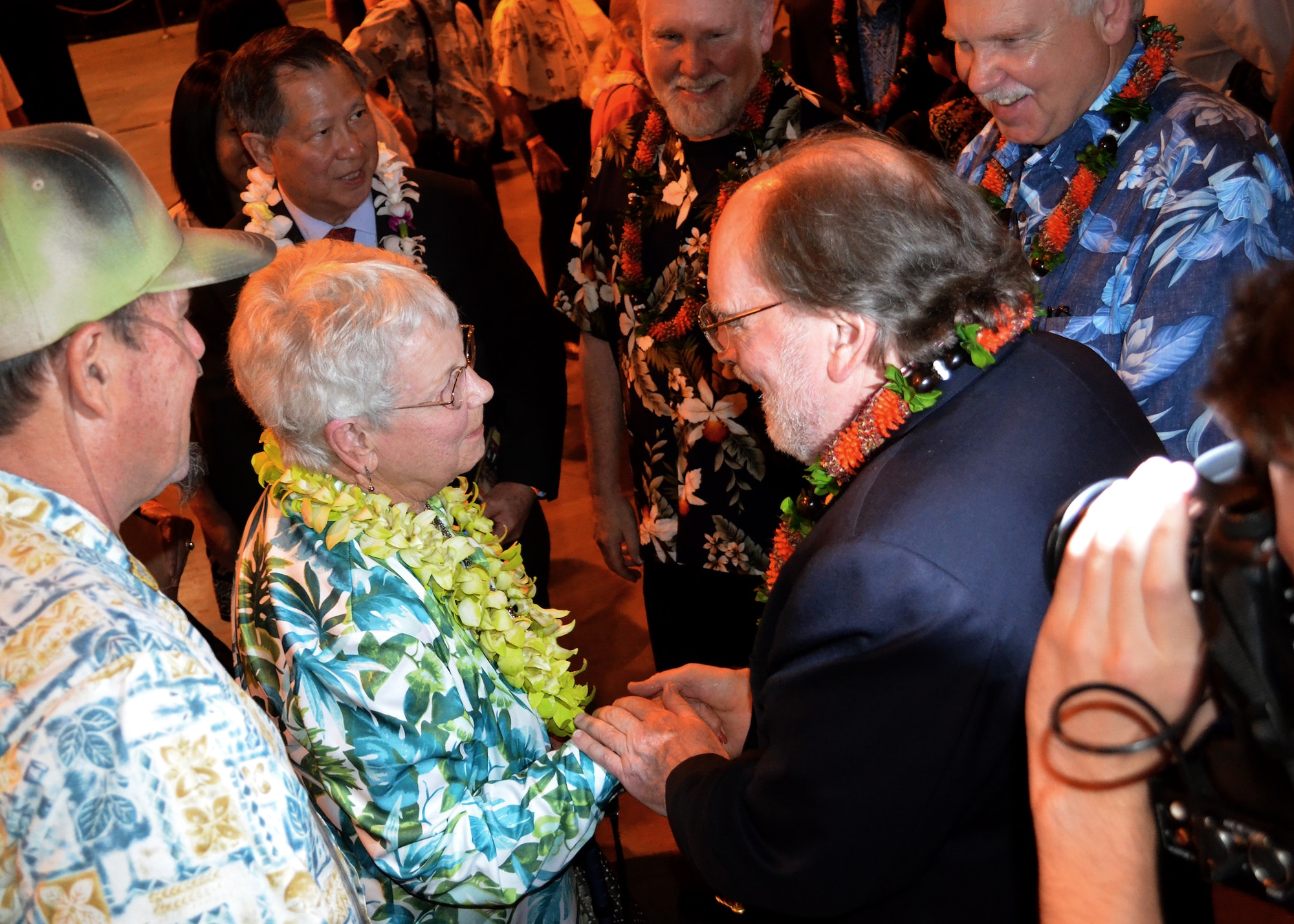 FORD ISLAND, Hawaii--Hawaii Gov. Neil Abercrombie thanks Mrs. Elinor Beneda, spouse of the late Lt. Glen Beneda, a ‘Flying Tigers’ fighter pilot with the 14th Air Force, at an event celebrating the legacy of the U.S.-China friendship, held at the Pacific Aviation Museum, Ford Island, Hawaii, Jan. 30, 2012. During the event, the President of the Chinese People’s Association for Friendship with Foreign Countries, Madame Li Xiaolin, presented her film documentary, Touching the Tigers, which tells the story of Beneda, who was shot down and wounded while defending China from Japanese forces during World War II. The documentary also details how Chinese farmers and soldiers helped Beneda escape capture before he was returned to a U.S. air base for medical care. (U.S. Air Force photo/Tech. Sgt. Jerome S. Tayborn/Released)