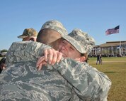 Trainee Lori Huayacla, 322nd Training Squadron, Flight 224, hugs her son, Airman Basic Justus Sanchez, following his graduation from basic training Jan. 27 at Joint Base San Antonio-Lackland, Texas. Senior leaders from the 37th Training Wing allowed Huayacla to attend the Airman Coin and Retreat ceremony and graduation parade. She is now in her third week of basic training. (U.S. Air Force photo/Alan Boedeker)